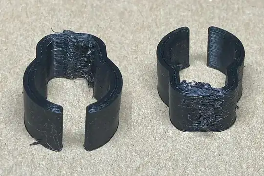 Photo of the front and back of a 3D printed clip showing extra extrusion