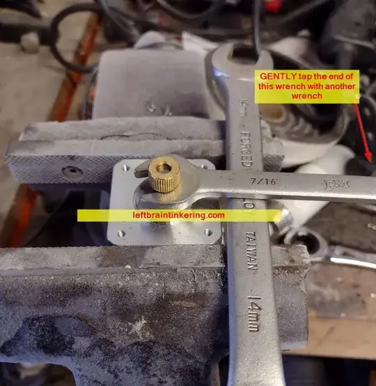 Using a couple of wrenches to pop the brass gear off of the motor Using a couple of wrenches to pop the brass gear off of the motor