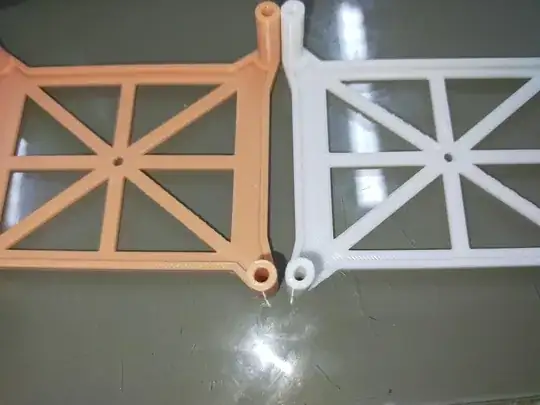 Photo of two 3D printed models a peach-colored model with its holes circular and a white model with its holes oval Photo of two 3D printed models a peach-colored model with its holes circular and a white model with its holes oval